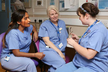 Picture of three clinical staff talking