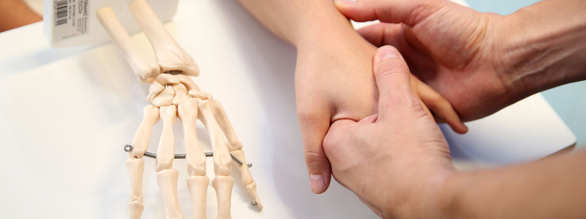 Picture of a skeletal hand and a hand holding another hand