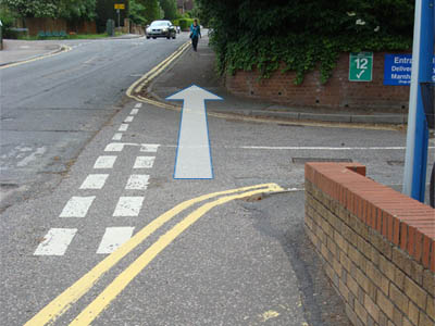 Picture of the right hand pavement going up Hillfield Road, crossing entrance B to the Hospital