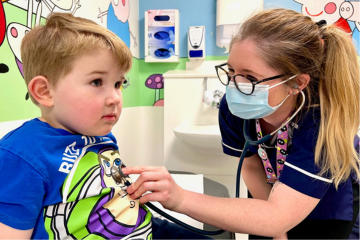 Picture of a nurse holding a stethoscope on a child's chest