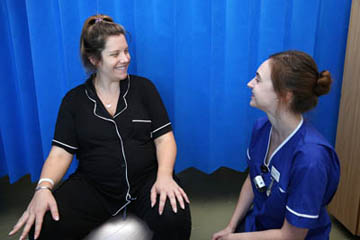 Picture of a patient talking to a member of the Maternity staff