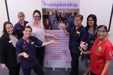 Picture of nurses in fromt of a stand advertising preceptorships at West Herts teaching hospitals