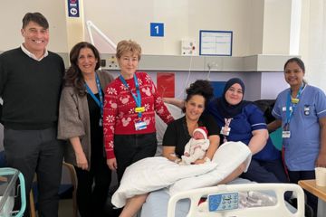 Picture of staff with mum holding a baby