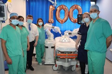 Picture of surgical team with Dean Russell and robots;