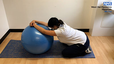 Picture of a person resting on a large ball