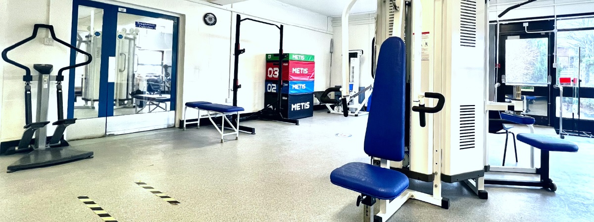 picture a large, spacious gym with exercise bikes, treadmill, stepper, leg press and weights benches as well as parallel bars for gait re-education