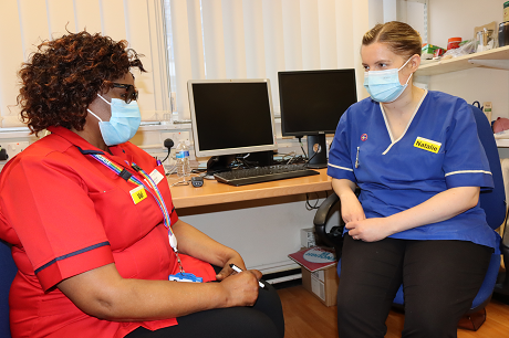 Picture of a two nurses talking to each other in a room
