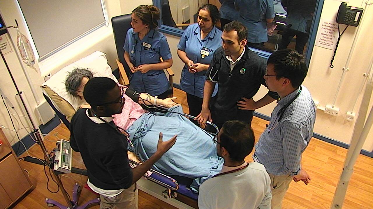 Picture of a multidisciplinary team speaking about a simulated patient's care pathway