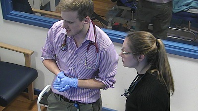 Picture shows two colleagues having a discussion regarding a simulated patient.