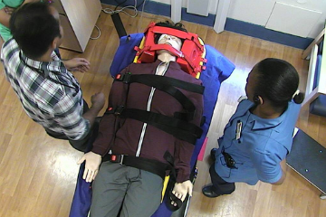 picture showing a doctor and nurse reviewing a trauma manikin in head blocks